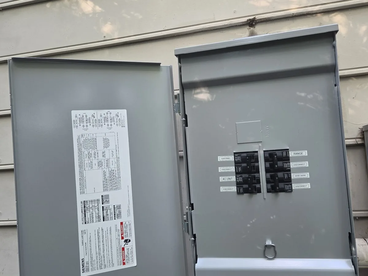 Open electrical panel with labeled breakers and safety instructions on the door