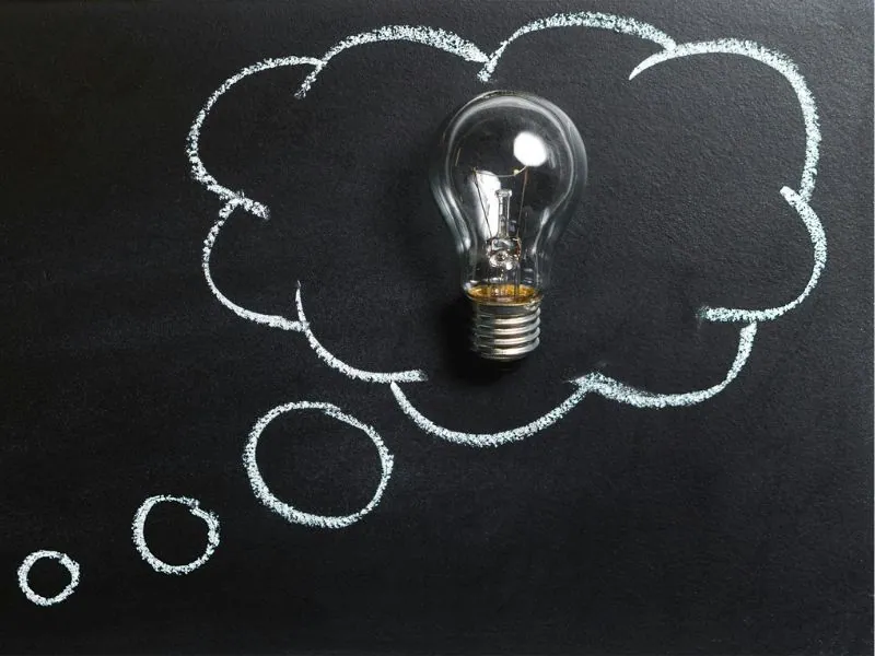Light bulb inside a chalk-drawn thought bubble — diagnosing flickering lights
