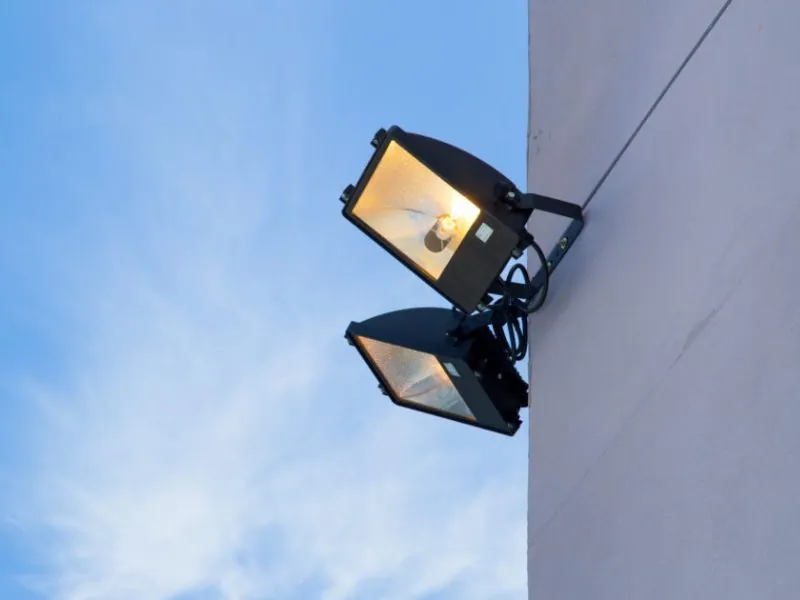 Dual floodlight security fixture mounted on a home's exterior corner