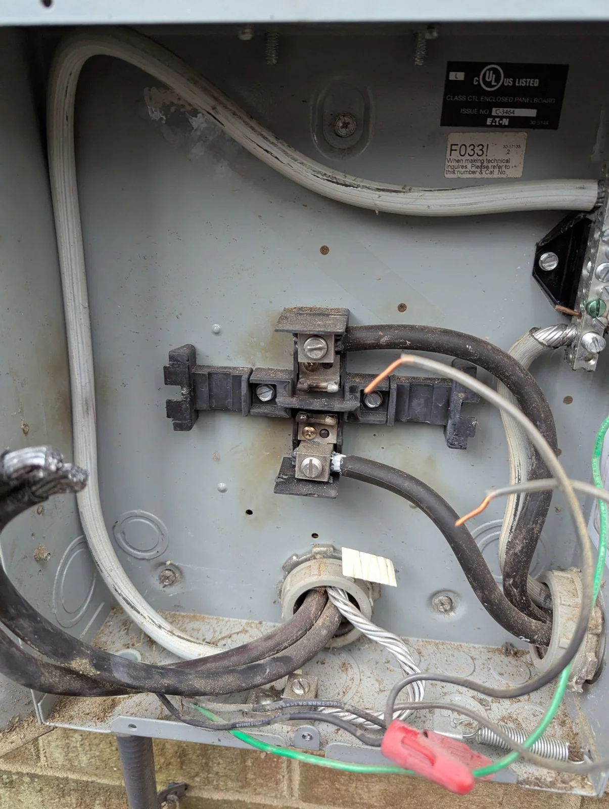 Open electrical enclosure with exposed wires and connectors, showing dust and wear, in Hayes Barton, Raleigh
