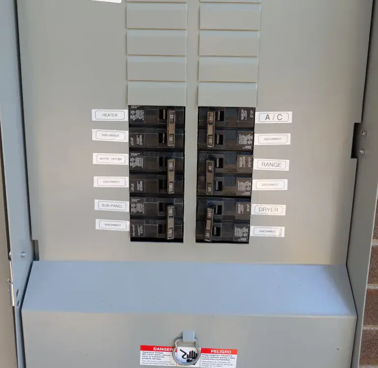 Labeled breakers and 200-amp main disconnect inside the completed Siemens meter-main panel in Raleigh, NC