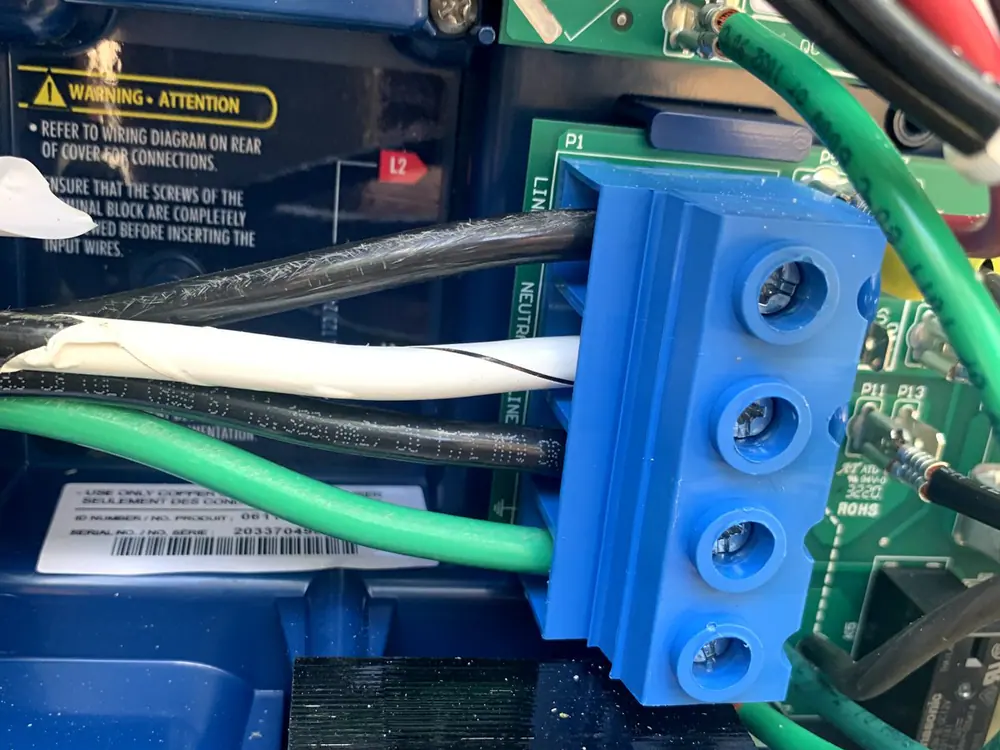 An open electrical enclosure with wires connected to a blue terminal block inside, in Mordecai, Raleigh