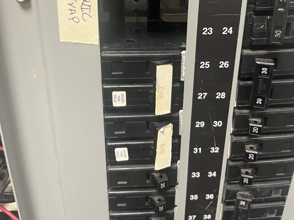 Electrical panel with labeled breakers and a handwritten note reading WIC and EVAP in Oakwood, Raleigh