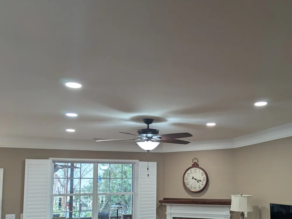 Recessed lights and ceiling fan installed in a Durham living room