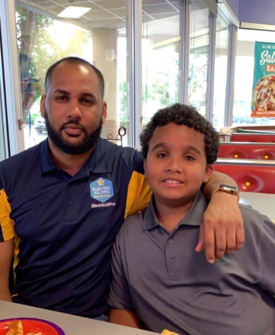 Hugo Balbuena, owner of Electric All Pro, with his son