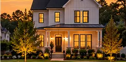 New two-story home with a small front lawn at dusk