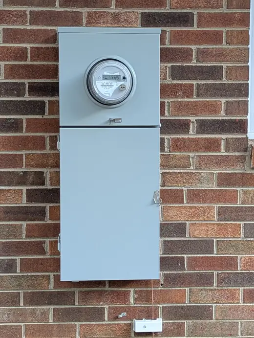 Closed Siemens 200-amp meter-main panel mounted on a brick exterior in Raleigh, NC