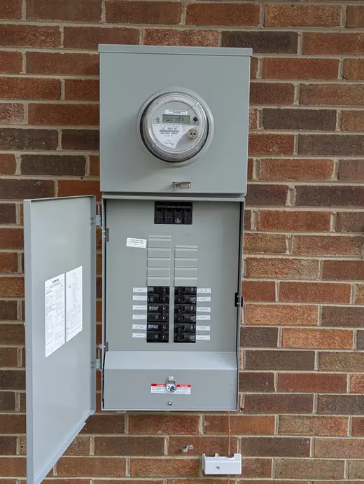 Completed Siemens 200-amp meter-main panel open with circuit labels at a Raleigh home