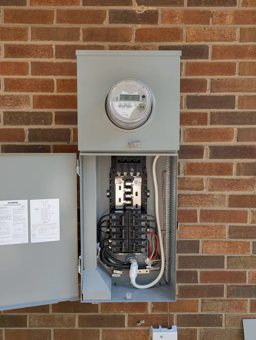 Full interior view of a completed Siemens 200-amp meter-main panel showing breakers and wiring in Raleigh