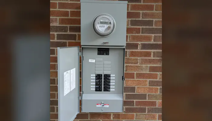 Completed Siemens 200-amp meter-main panel open on the brick exterior of a Raleigh home