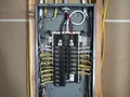 Labeled basement electrical subpanel installed during a Raleigh panel upgrade
