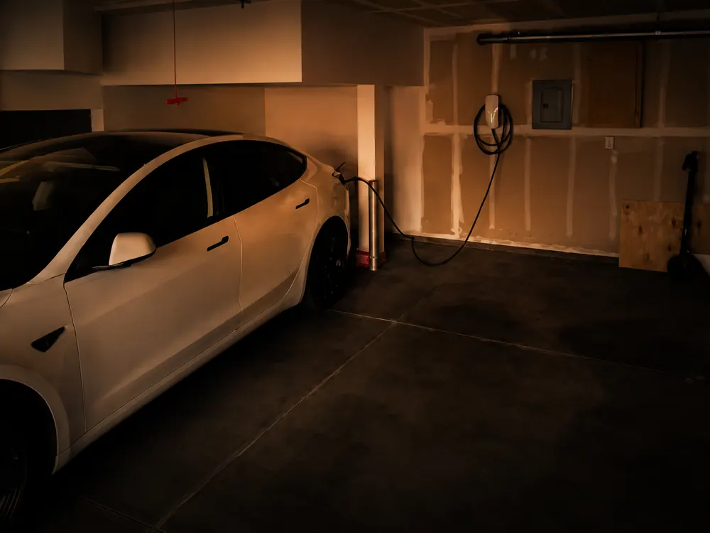 Tesla charging from a professionally installed home EV charger in a Raleigh, NC garage