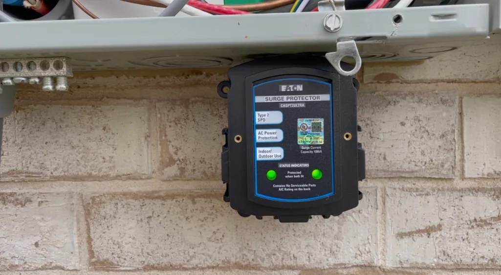 Installed Eaton Type 2 whole-house surge protector with both green status lights illuminated