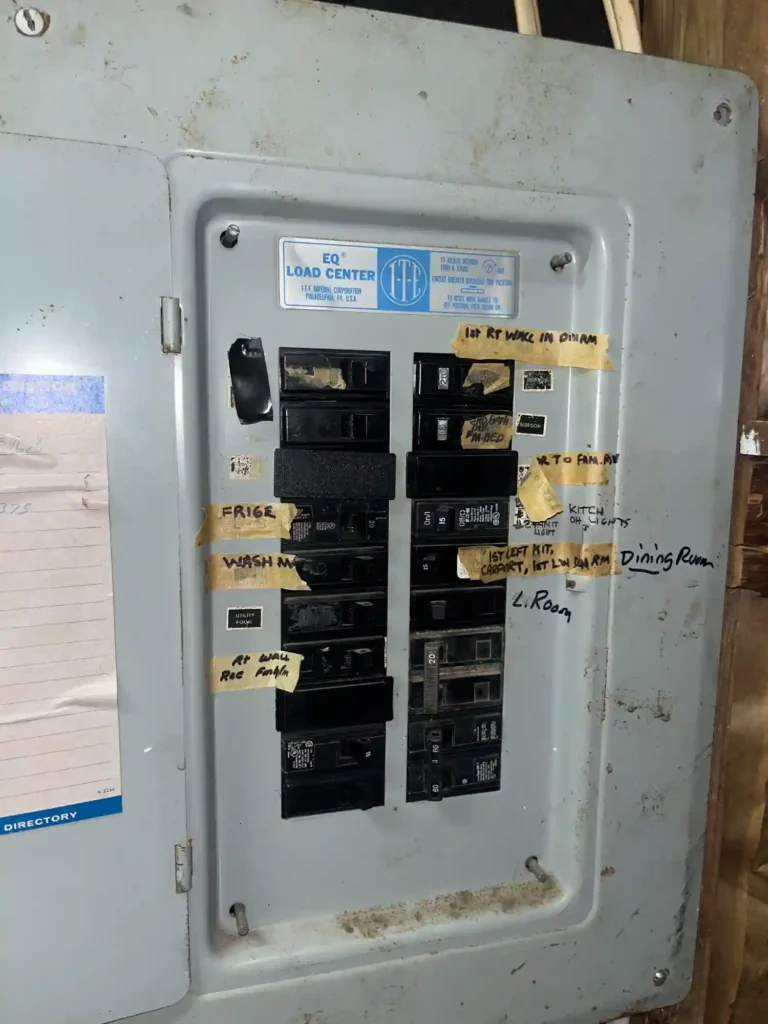 Original Interior Electrical Panel In Basement Showing Labeled Breakers Before Service Replacement.