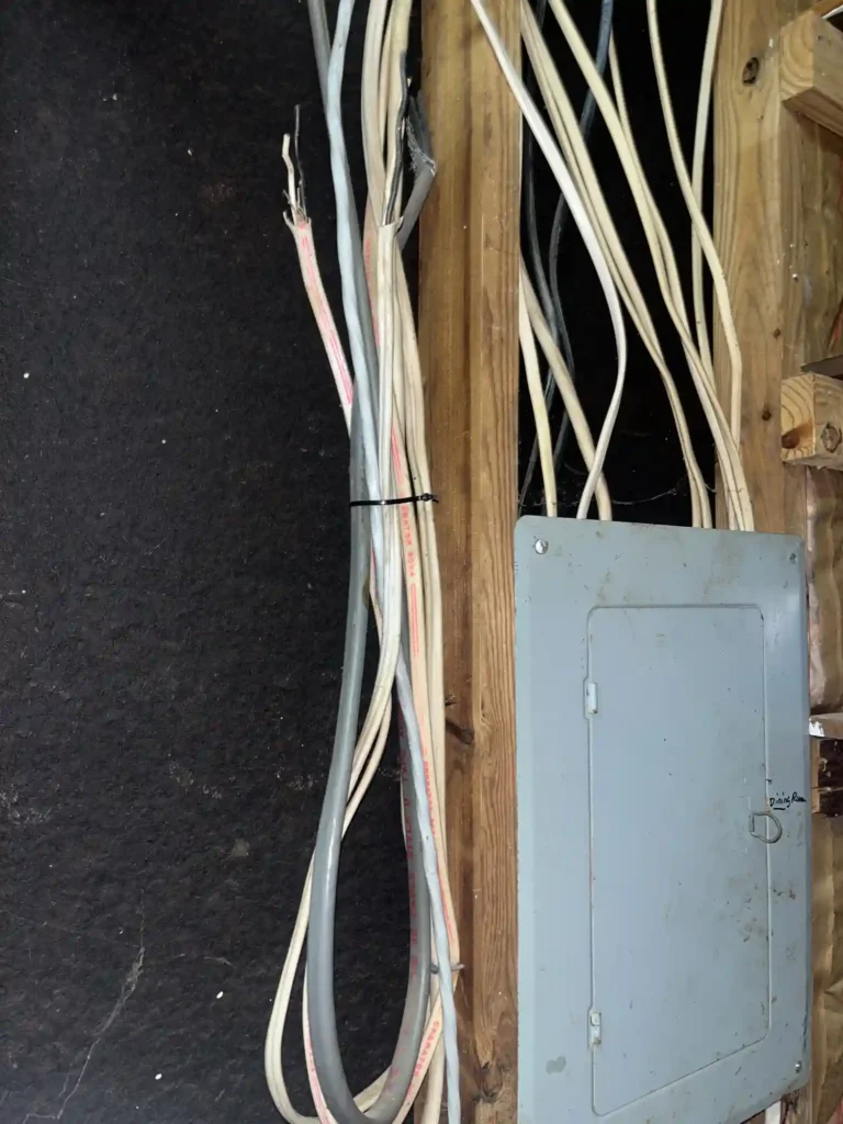 Interior Electrical Subpanel Location With Exposed Wiring In Basement Before Electrical Upgrade.